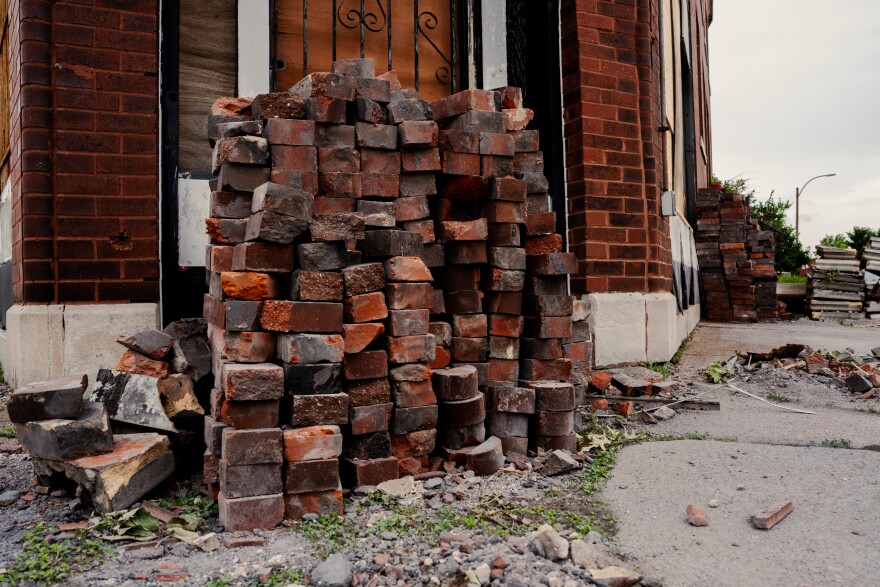 Bricks are stacked outside of a tornado-damaged home on Monday, May 19, 2025, in north St. Louis.