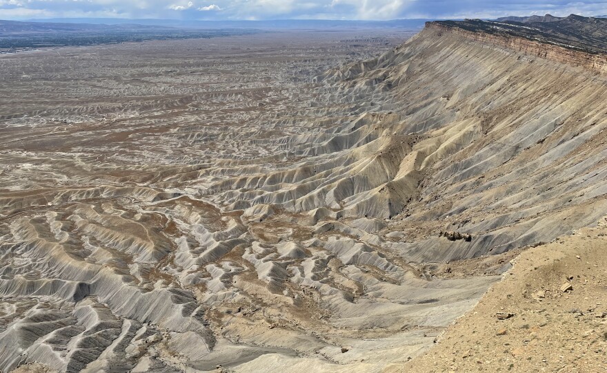 The Bookcliffs line the northern boundary of western Colorado's Grand Valley on May 31, 2022. While the valley sits just below the Rocky Mountains' snowy peaks, it is a high desert and relies on irrigation water to make agriculture possible.